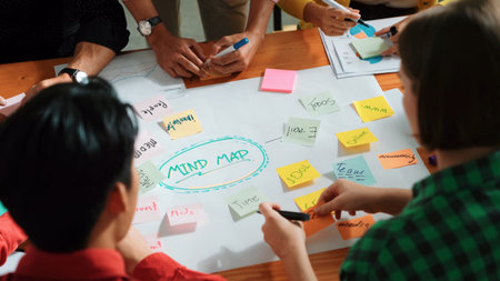 Top view of business team in casual cloth hand writing idea on sticky notes. Closeup of diverse...
