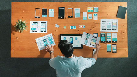 Top view of skilled caucasian software developer looking at develop plan while planning strategy by...