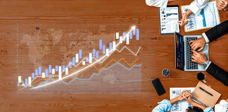 Professionals engaged in a business meeting analyzing stock market trends and financial data on...