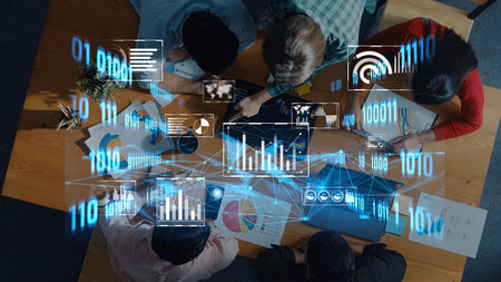 A creative team engages in collaboration while analyzing data on digital interfaces. The environment...