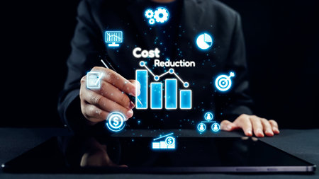 A business professional engages with digital tools to analyze cost reduction strategies. Visualizations of graphs and data highlight growth potential and efficiency gains.の写真素材