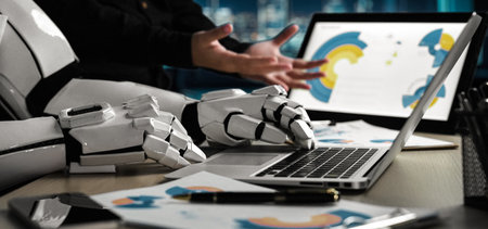 A sleek robotic arm interacts with a laptop and documents in a modern workspace, showcasing the...