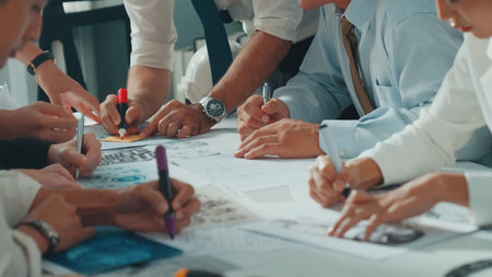 Top view of engineer pointing at turbine engine at meeting table with equipment. Aerial view of professional project manager talking and discussing about electronic generator system.の写真素材