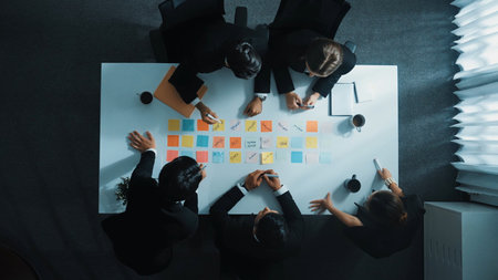 Top view of professional business people working on sticky notes. Project manager writing marketing idea on paper while discuss about financial plan. Communication technology concept. Directorate.の写真素材