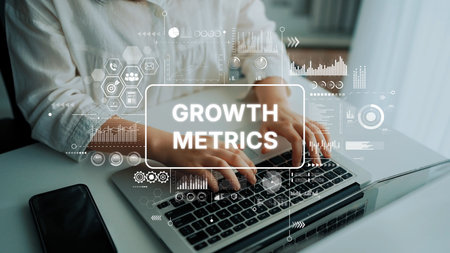 Hands Typing on Laptop with Data Visualization Graphics Representing Growth Metrics and Analytics in Modern Workspace. Asymptotic smart data analytic.の写真素材
