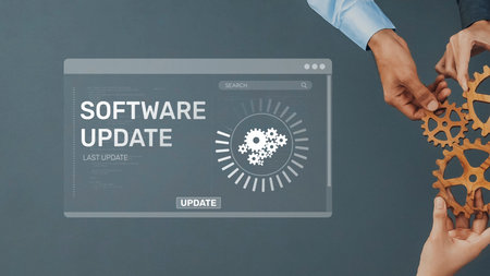 This image captures hands manipulating gears alongside a software update interface, symbolizing teamwork and technological innovation in development and progress. Rasterの写真素材
