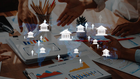 A dynamic business meeting showcasing hands engaged in discussion over charts and graphs, illustrating global financial trends and collaborative planning strategies. Rasterの写真素材