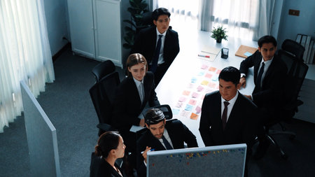 Top view of skilled business team explain plan while project managers listening presentation. Group of diverse people sitting at meeting table with sticky notes while brainstorming idea. Directorate.の写真素材