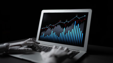 A robotic hand engages with a sleek laptop showcasing an impressive financial data visualization, symbolizing the fusion of technology and analytics in modern business.の写真素材