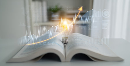 A captivating image of an open book with a light bulb showing an upward trend, representing the connection between knowledge, innovation, and business growth.の写真素材