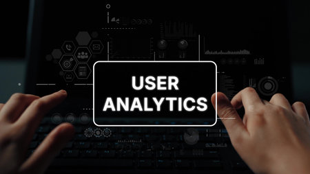 Hands interacting with data visualizations on a laptop showcasing user analytics metrics and...