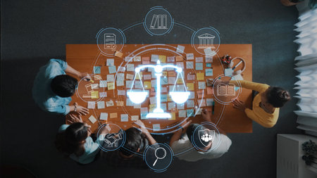 A diverse team engages in a collaborative legal brainstorming session, analyzing concepts around justice and law practices, with notes and tools on the table. Rasterの写真素材