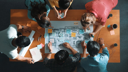 Top view of civil engineer writing and planning by using sticky notes to brainstorm idea. Top down aerial view of business people taking a note at table with project plans and equipments. Symposium.の写真素材