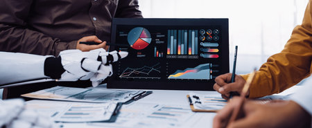 A diverse team collaborates in a modern office, discussing data analysis and insights. The robot interacts with digital displays featuring charts and graphs.の写真素材
