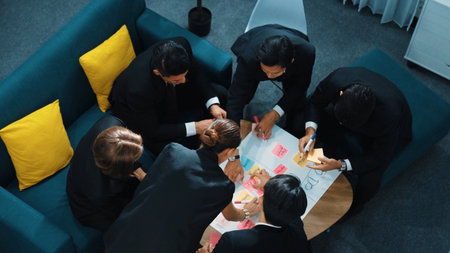 Top view of smart business team write marketing plan and putting stick notes on mind map. Group of happy business people brainstorm financial idea and planning strategy at meeting room. Directorate.の写真素材