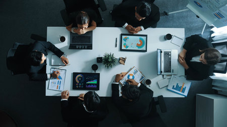 Top view of executive manager present growth graph while smart team clap hands and shale hand with marketing group to celebrate successful project. Represented love, teamwork and unity Directorate.の写真素材