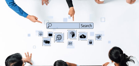 A diverse group of professionals works together, engaging in brainstorming around a table with digital icons that symbolize online search and technology.の写真素材