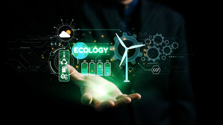 A businessman holds a holographic representation of ecology and sustainability, featuring wind...