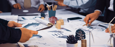 A diverse team engages in a collaborative meeting focused on sustainability strategies, utilizing...