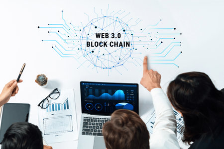 A group of professionals engages in a serious discussion about Web 3.0 and blockchain technology while reviewing data visualizations on a laptop in a modern office setting.の写真素材