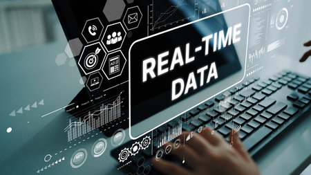 Hands on Keyboard with Real-Time Data Visualization on Screen Representing Modern Technology and Innovative Solutions. Asymptotic smart data analytic.の写真素材