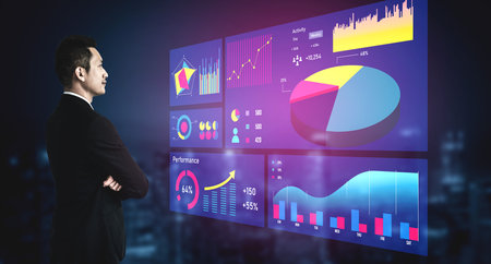 A focused professional man stands before digital screens displaying various business analytics, charts, and graphs, emphasizing technological innovation and data-driven decision-making. Imputeの写真素材