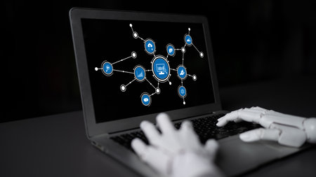 A captivating image illustrating a robotic hand engaging with a laptop interface displaying interconnected digital elements, symbolizing advancements in artificial intelligence and technology. Tesselの写真素材