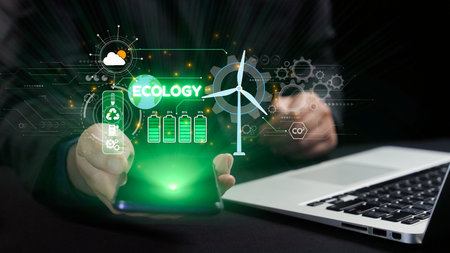 This image represents the intersection of technology and ecology, depicting a hand holding a smartphone showcasing graphics symbolizing renewable energy and sustainability advancements.の写真素材