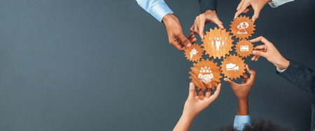 A group of diverse individuals gathers around to hold wooden gears with icons, symbolizing teamwork and business strategies, portraying collaboration in the modern workplace.の写真素材