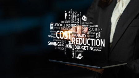 A business professional interacts with a tablet highlighting key concepts related to cost reduction, budgeting, and efficiency in a modern corporate environment. Tesselの写真素材