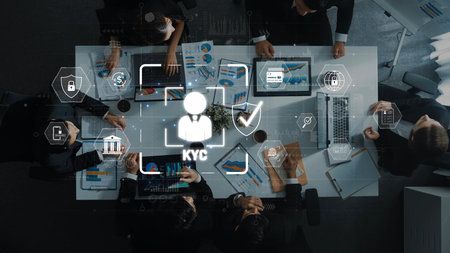 A professional team collaborating on Know Your Customer strategies using data visualizations and security icons, emphasizing financial compliance and teamwork in a modern workspace. Rasterの写真素材