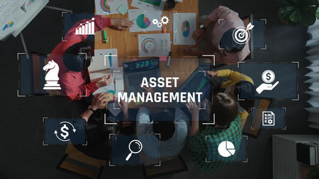 A collaborative team discusses asset management strategies in a modern office, utilizing charts and graphs to enhance decision-making and productivity. Rasterの写真素材
