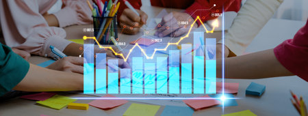 A group of professionals collaborates in a business meeting, analyzing graphs and charts surrounded...