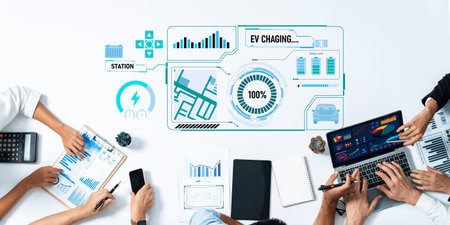 A modern workspace showcasing professionals collaborating on electric vehicle charging technologies,...