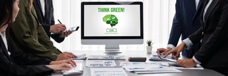 Panorama shot analyst team utilizing BI to analyze financial report with laptop. Businesspeople analyzing BI data dashboard displayed on laptop screen for business insight.の写真素材