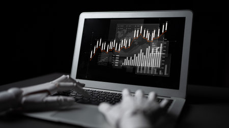 A futuristic robot hand explores a laptop screen filled with detailed financial charts and market analysis, showcasing the integration of technology in investment strategies.の写真素材