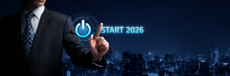 A businessman interacts with a digital power button, symbolizing the start of 2026 and the pursuit...