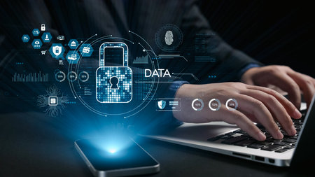 A conceptual image showcasing secure data protection through modern technology, featuring hands typing on a laptop with digital lock and cybersecurity graphics.の写真素材