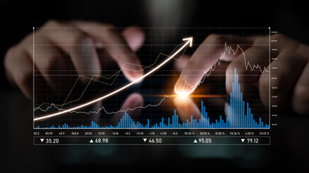 A close-up of hands analyzing stock market data on a digital screen. The image highlights trends,...