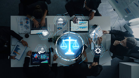 A dynamic team of legal professionals collaborating in a modern office setting, utilizing technology and innovative analytics to improve client services and enhance legal outcomes.の写真素材