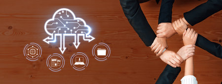 A group of business professionals joins hands symbolizing teamwork while embracing cloud technology....