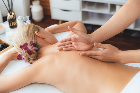 Caucasian woman customer enjoying relaxing anti-stress spa massage and pampering with beauty skin recreation leisure in day light ambient salon spa at luxury resort or hotel. Quiescentの写真素材