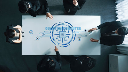 A diverse business team engages in a discussion about a quantum computing project, featuring digital...