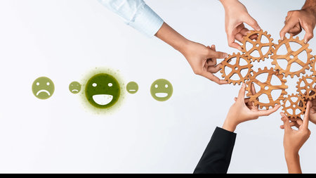 Hands interconnecting through gears embody teamwork and innovation, complemented by smiley faces, illustrating the importance of positive emotions in achieving success. Rasterの写真素材