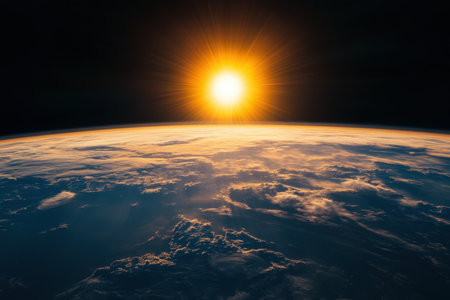 A breathtaking view of the Earth from space at sunrise, showcasing vibrant clouds and the warm glow of the sun illuminating the atmosphere, radiating tranquility and beauty.の素材