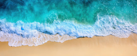 This stunning aerial view captures the turquoise ocean waves crashing onto a serene sandy beach, showcasing the beauty of nature and tranquility.の素材
