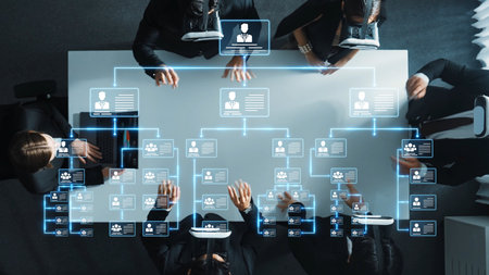 Aerial view of a professional business meeting showcasing digital interfaces displaying...