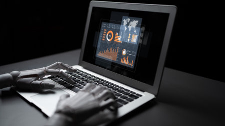 A robotic hand interacts with a laptop displaying vibrant data visualizations, symbolizing the convergence of technology and innovation in a sleek dark setting.の写真素材