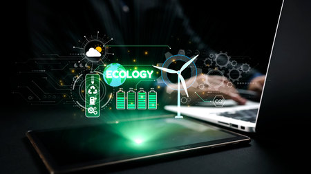 This image showcases digital graphics illustrating ecology and renewable energy concepts displayed on a laptop and smartphone, emphasizing innovation in sustainable technology.の写真素材