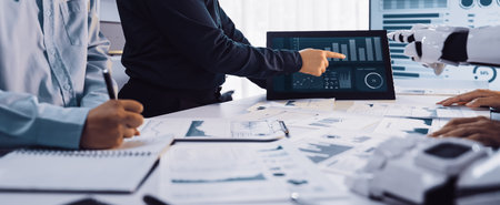 Professionals engage in data analysis with digital displays and documents in a modern office space,...